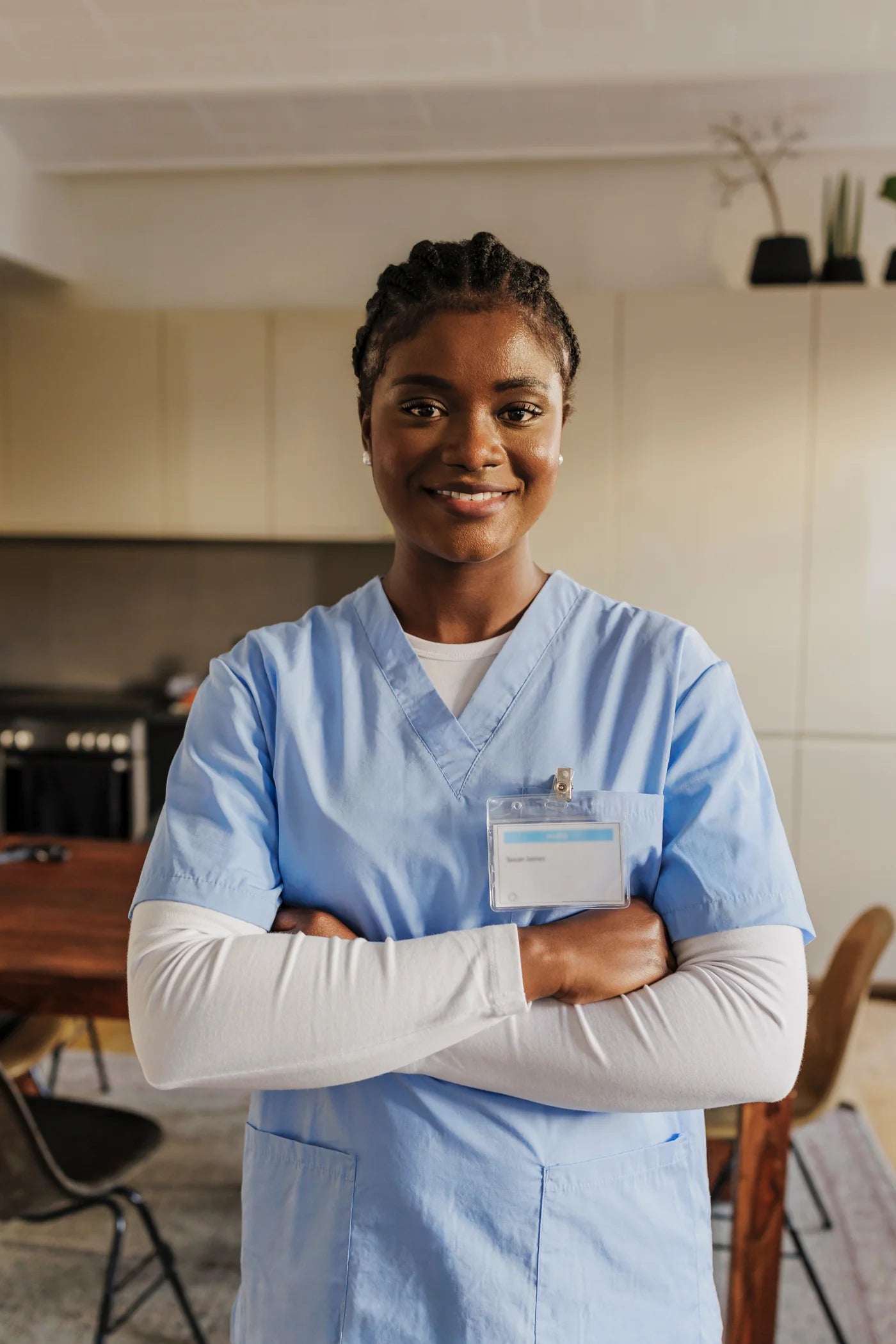 A smiling carer in blue scrubs